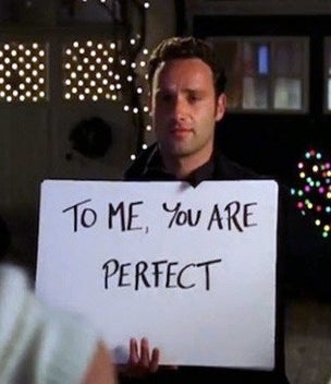 Andrew Lincoln as Mark in &quot;Love, Actually&quot; holds up a sign that reads, &quot;To me, you are perfect&quot;