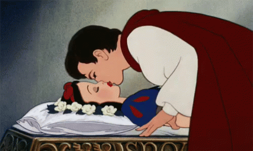 The prince kissing Snow White as she lays unconscious