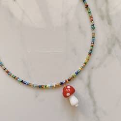 close up of the mushroom necklace with a beaded chain 