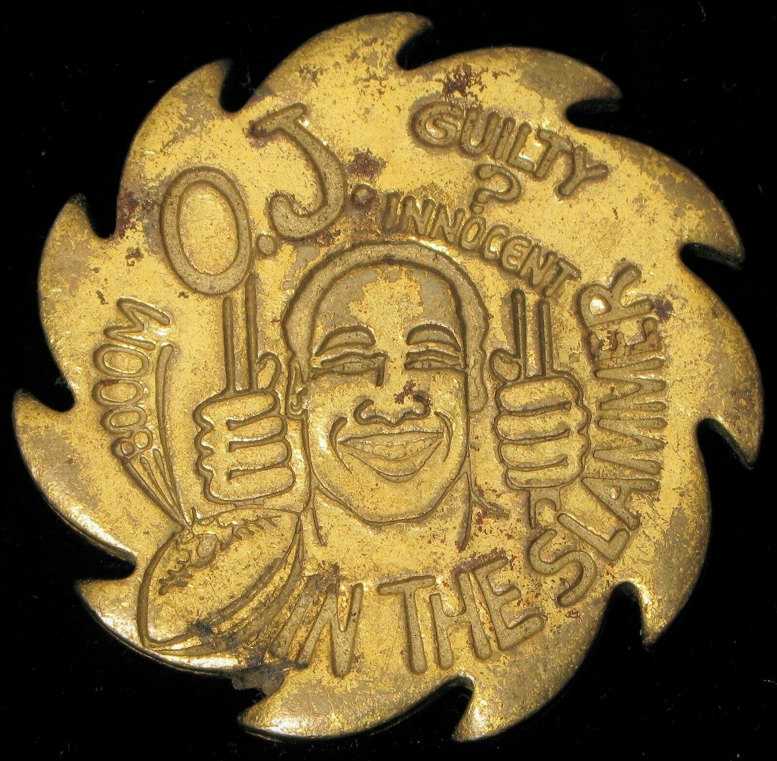 Gold slammer with etching of O.J. on it