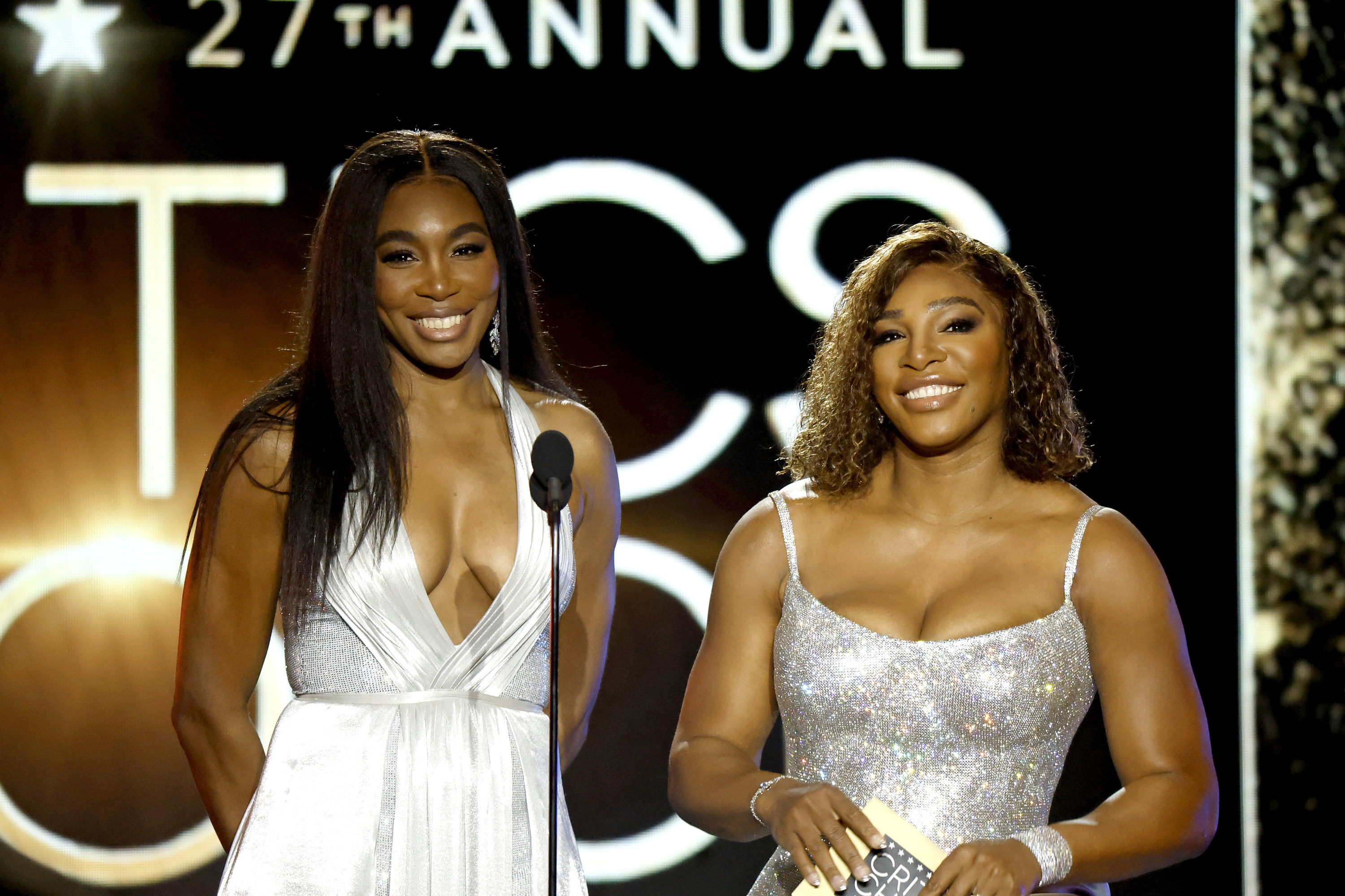 Serena and Venus smile while speaking onstage