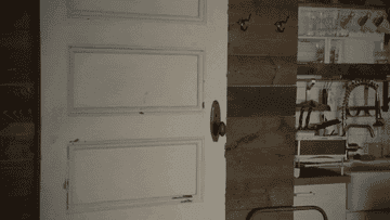 a gif of someone stepping out of a bathroom and removing a robe