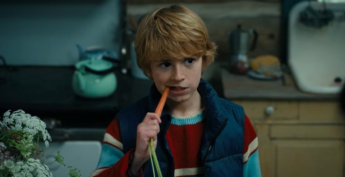 Young Adam taking a bite out of a carrot in &quot;The Adam Project&quot;