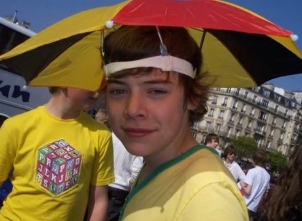 Harry Styles in 2009, wearing an umbrella hat.