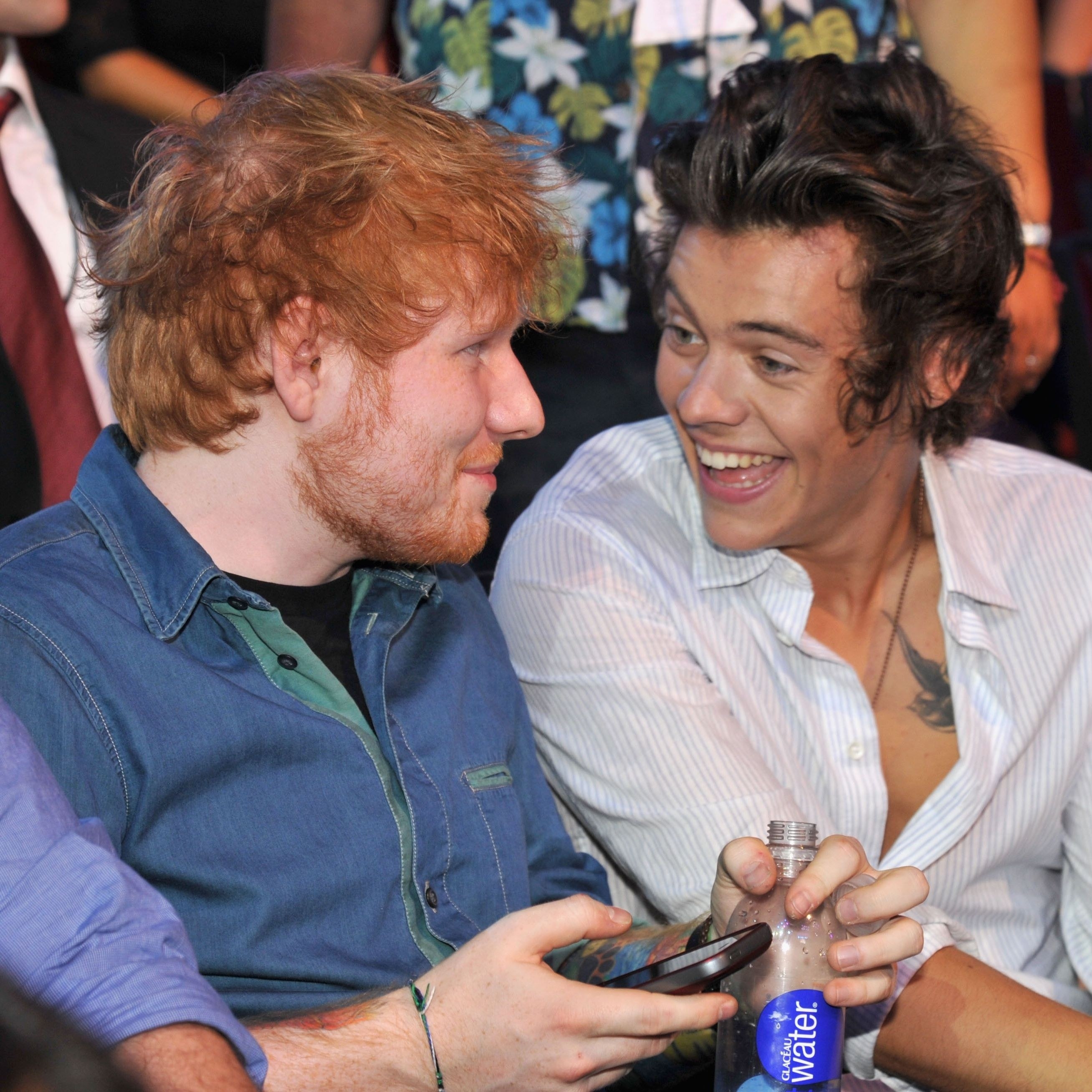Harry laughing at Ed Sheeran.
