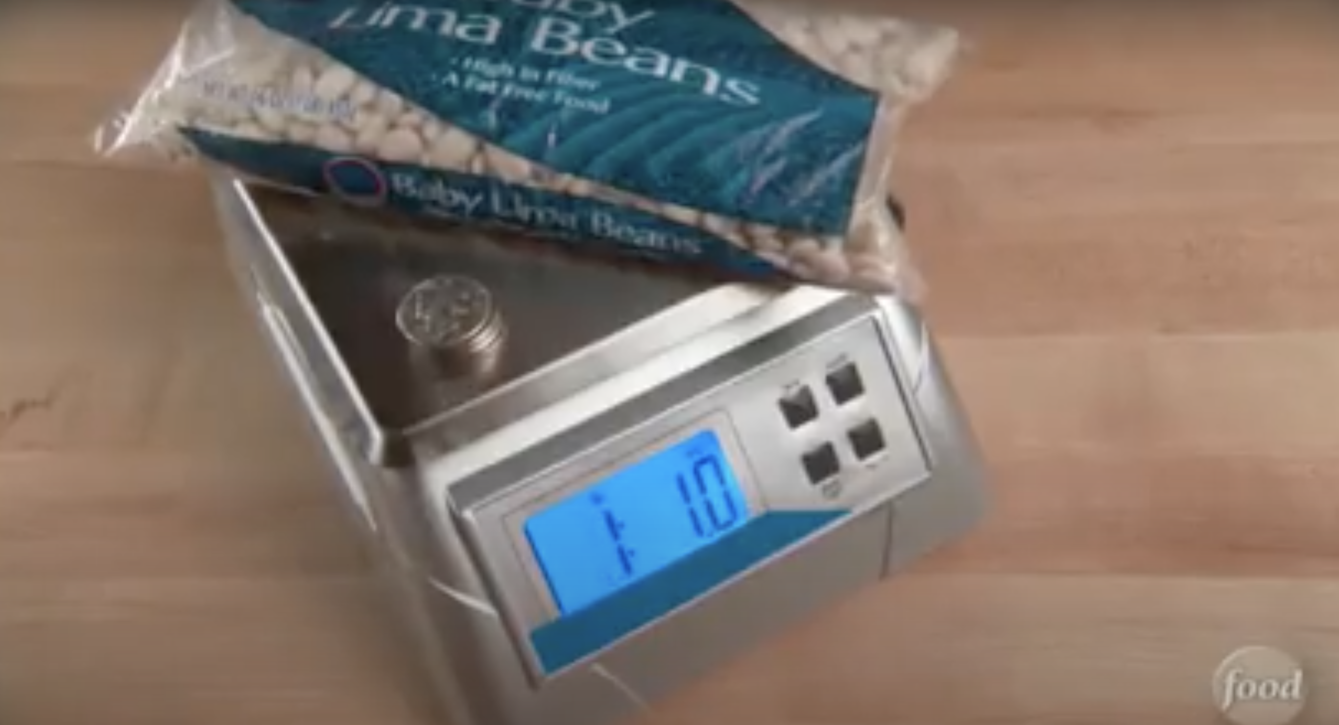 A bag of lima beans on a kitchen scale