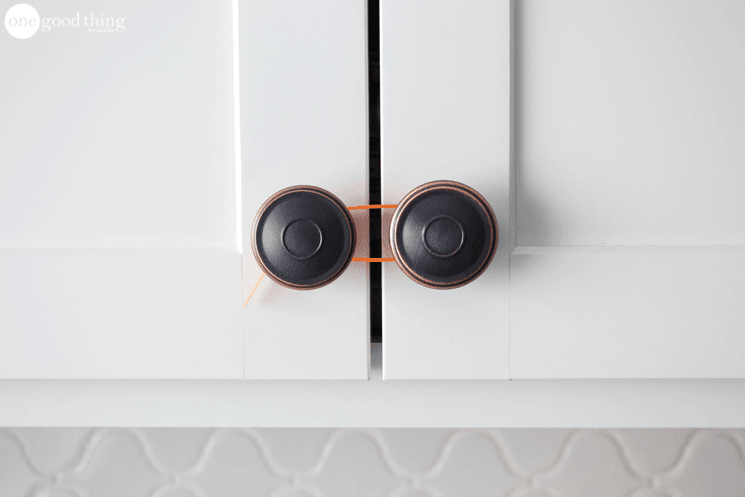 Blogger's photo of a zip tie around two cabinet handles