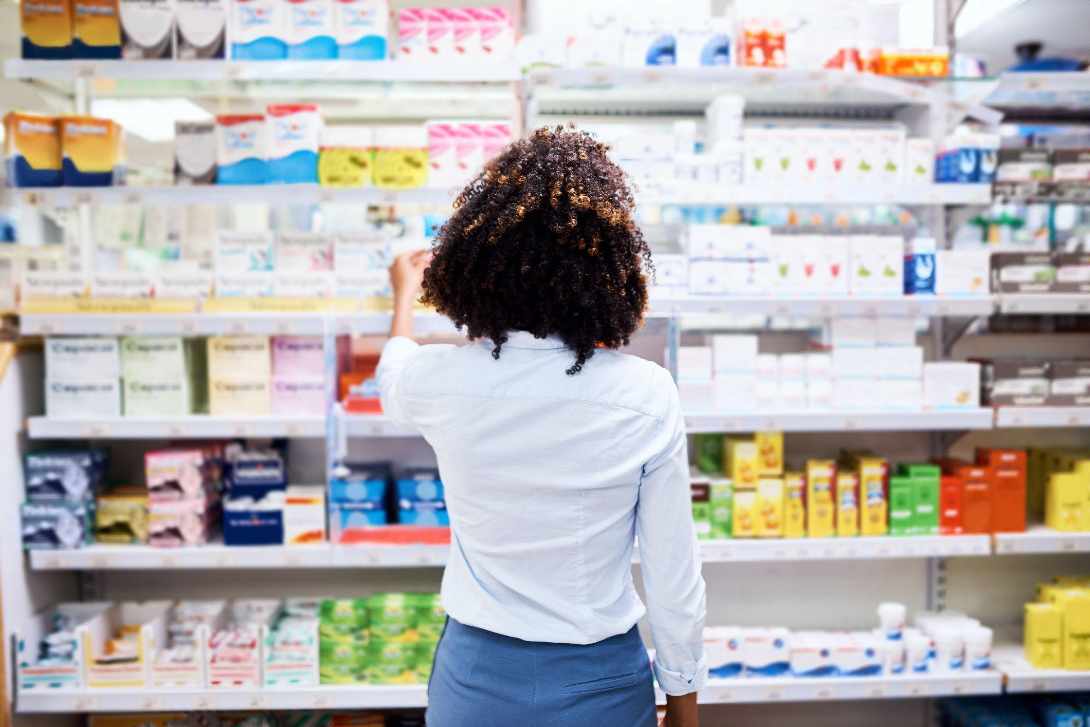 A woman in a pharmacy aisle
