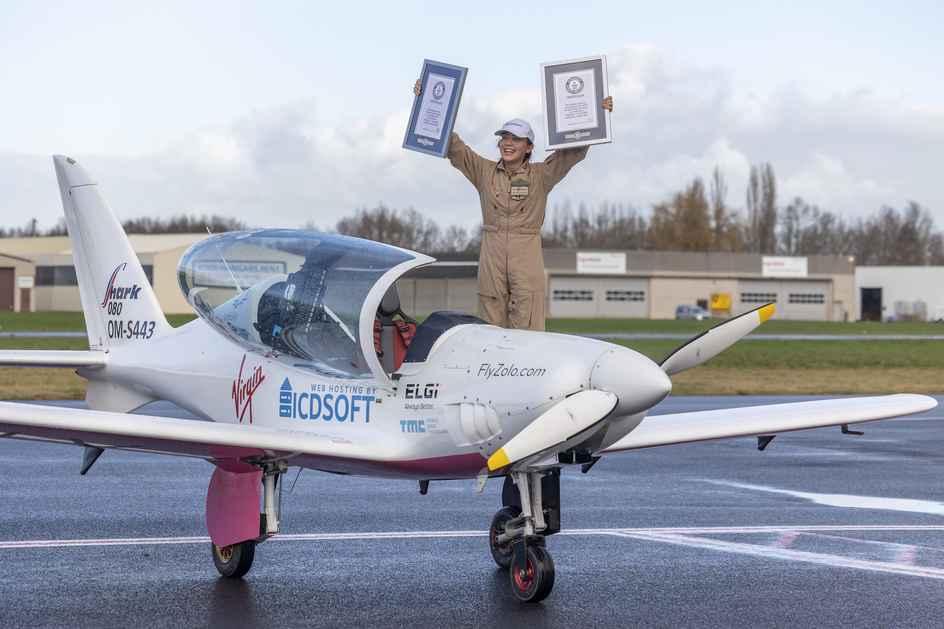 Zara Rutherford holding her Guinness Book of Records certificates after landing her ultralight Shark aircraft