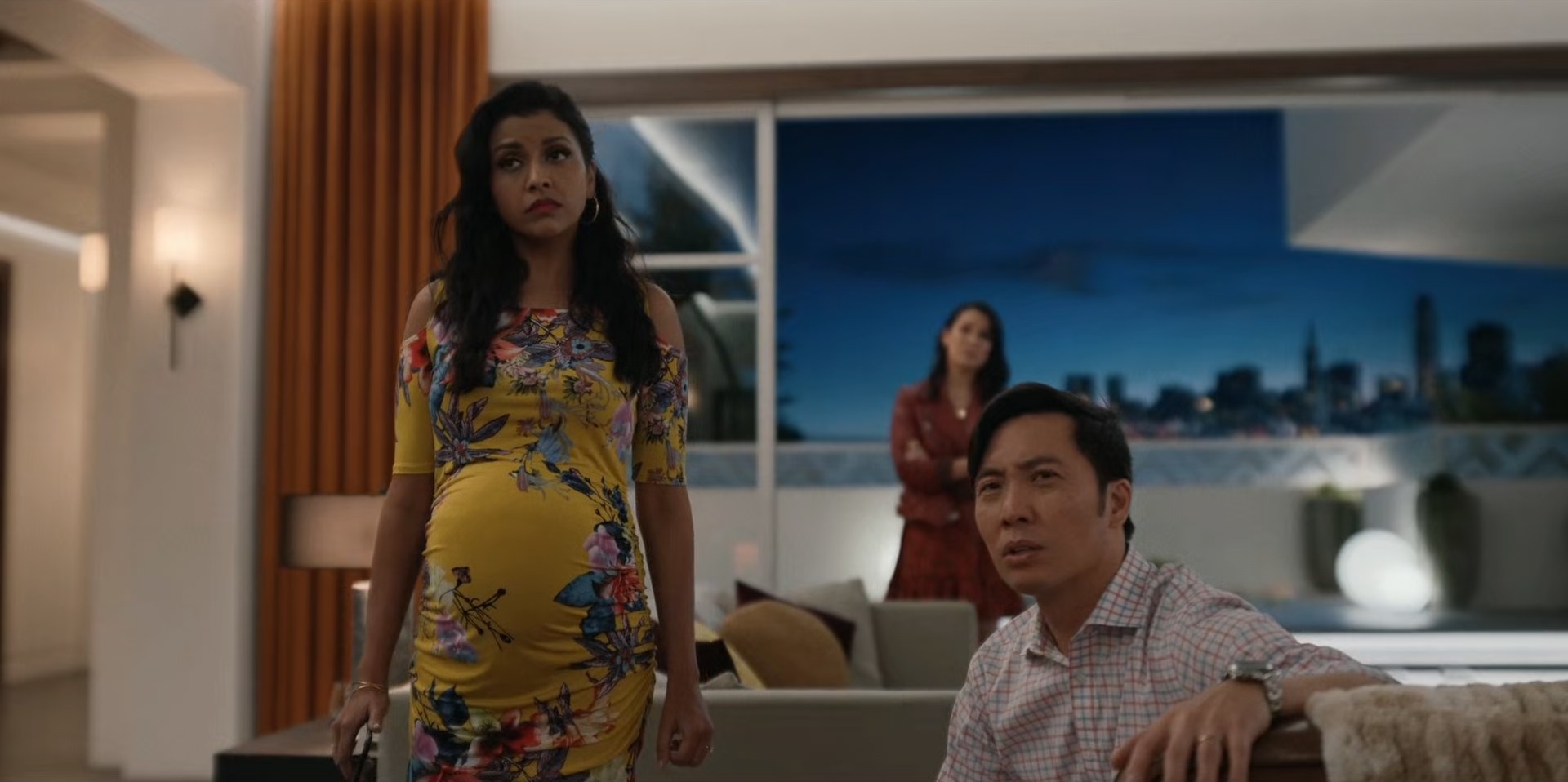 Tiya Sarkar and Kevin Yu in a living room with Zoë Chao far in the background