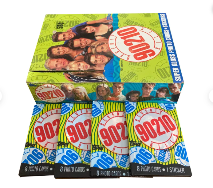 a &quot;90210&quot; card box with four wrapped card packs in front of it