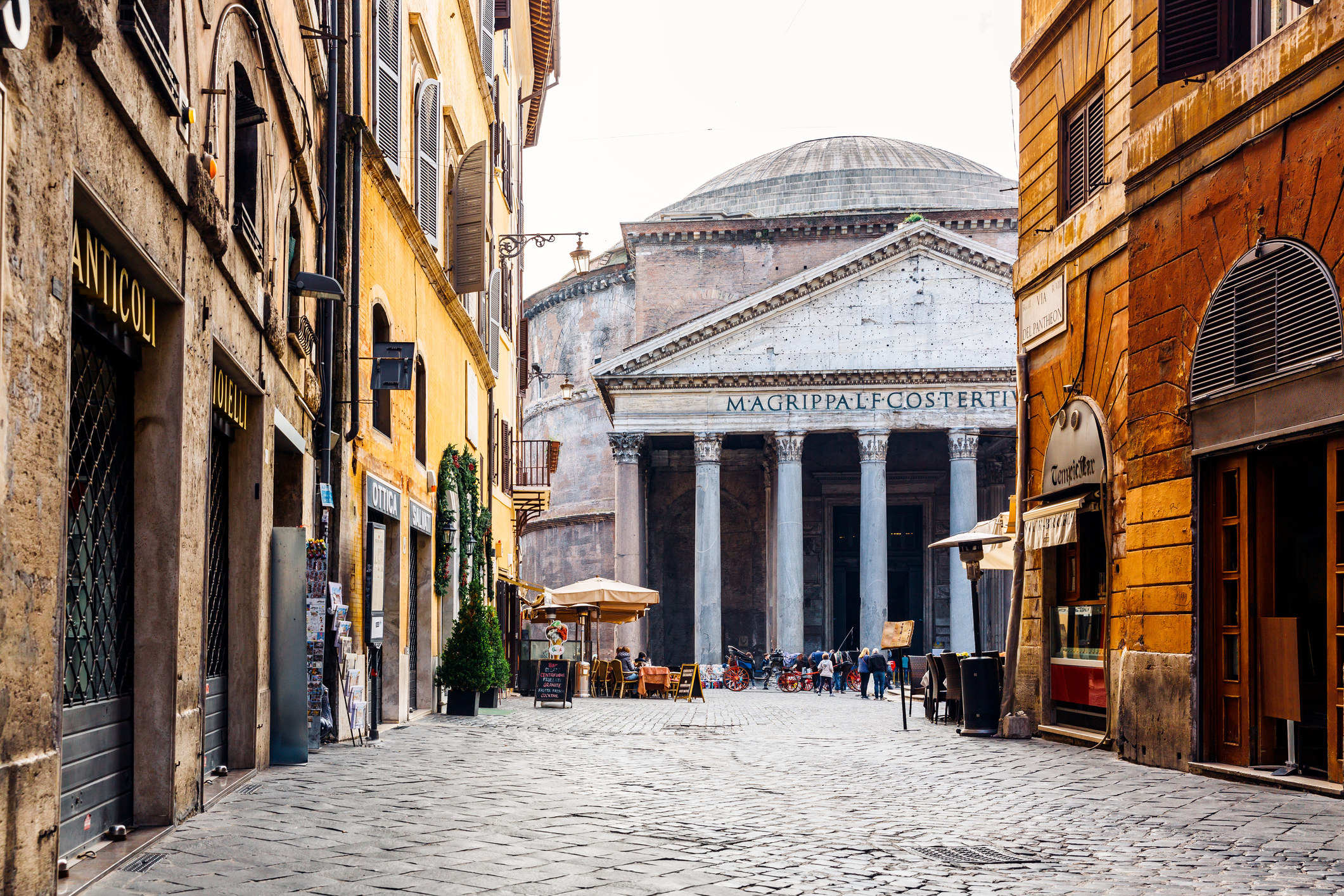 Old cobblestone street in Rome with the Pantheon in the center