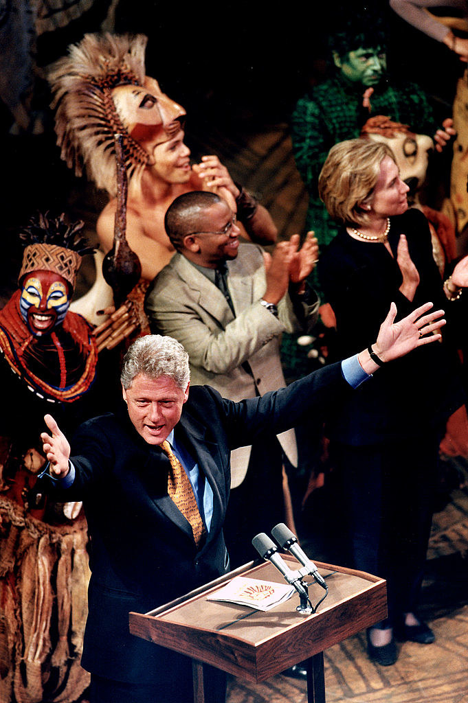 Bill and Hillary surrounded by the cast
