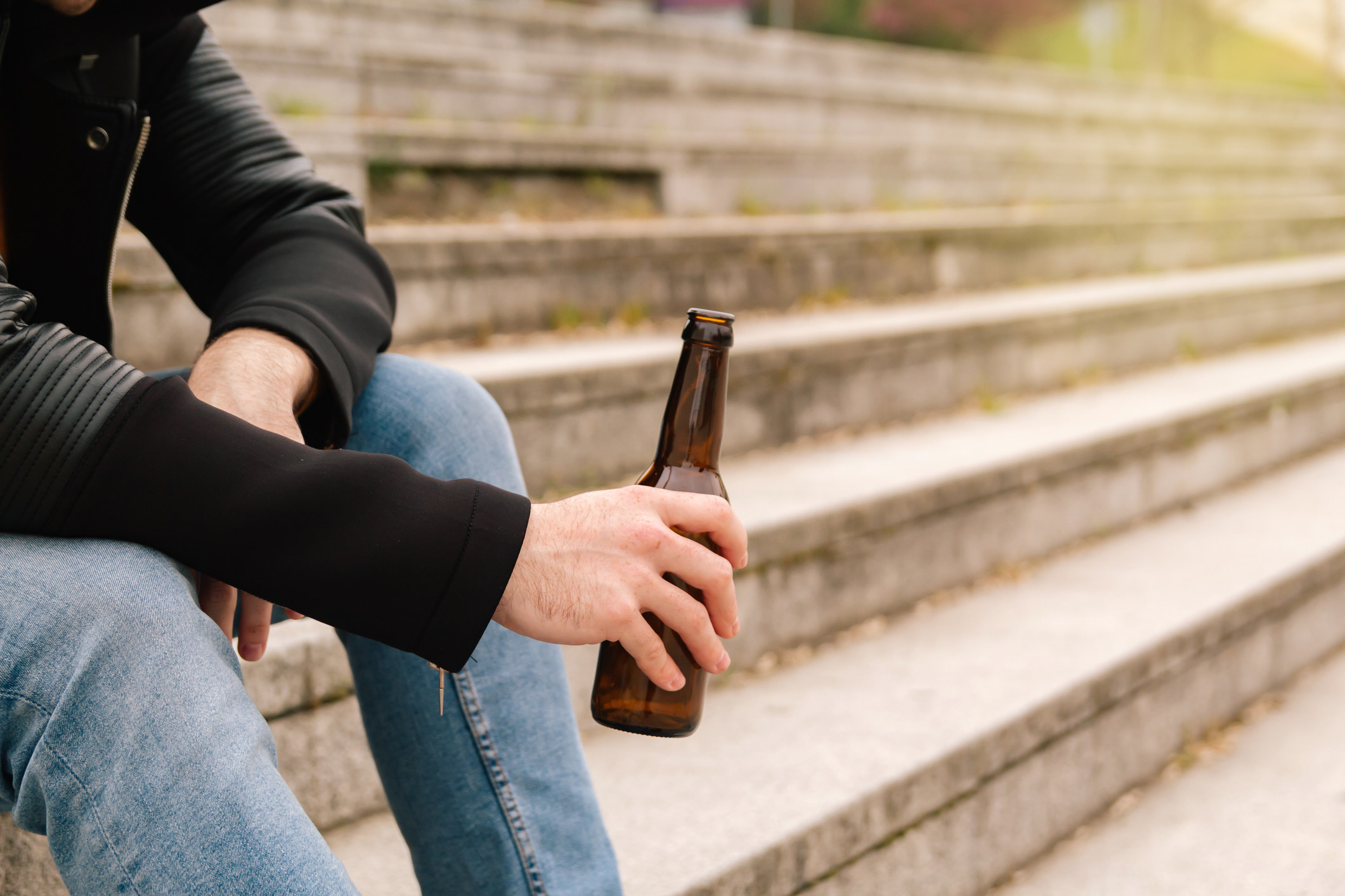 A person drinking a beer outdoors