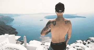 Justin Bieber standing on a balcony in Santorini, Greece