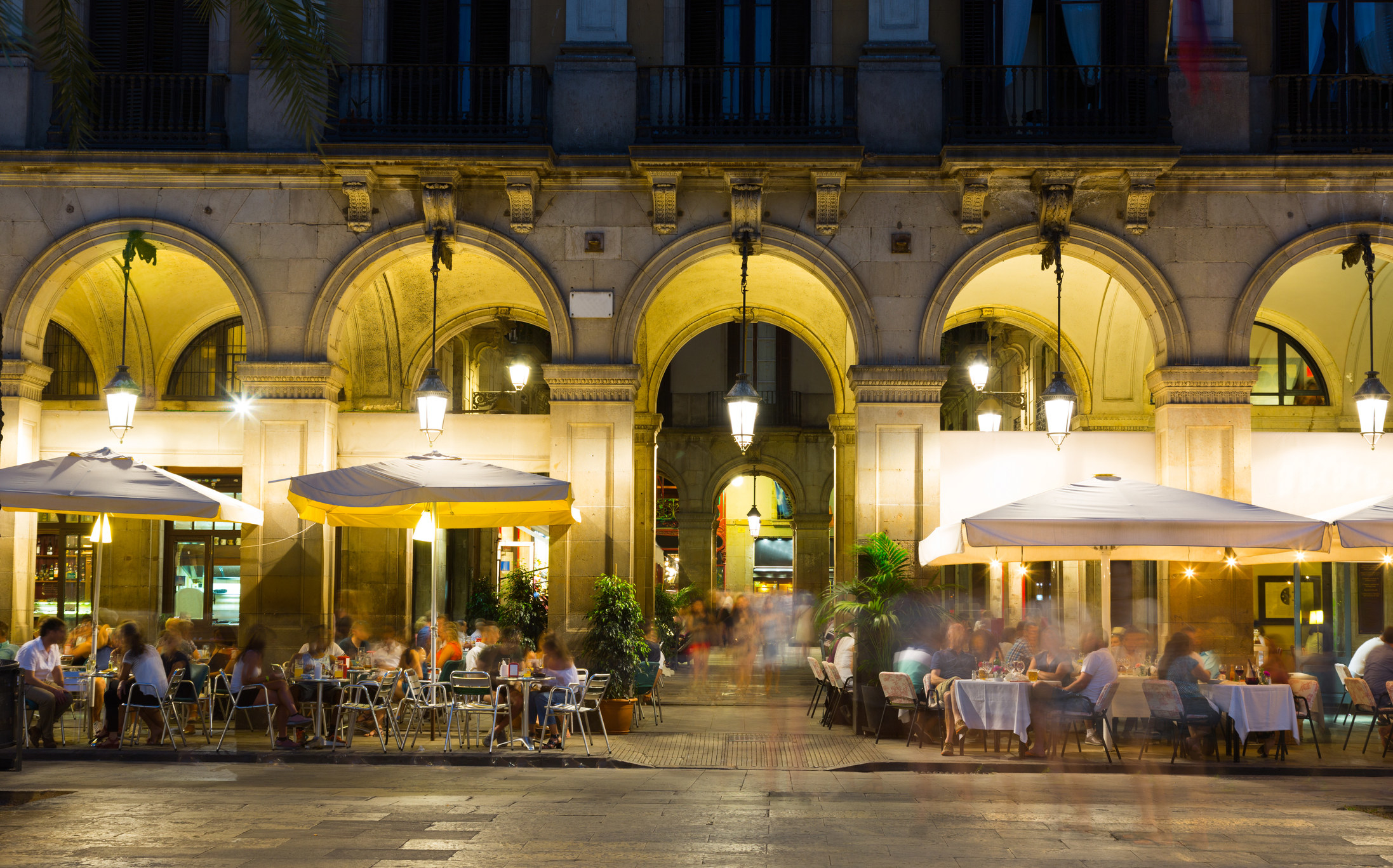 A plaza with tables at night