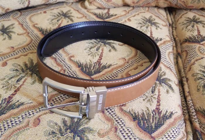 the belt in tan resting on a couch