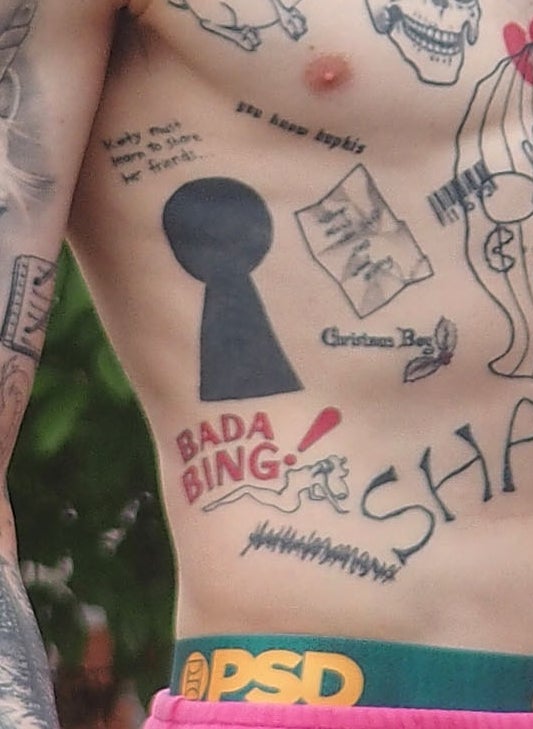 A closeup of the tattoos described