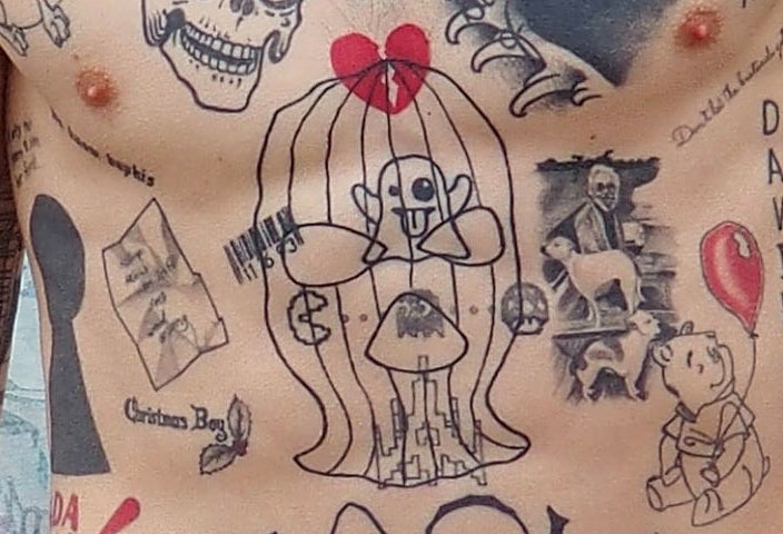 A closeup of the tattoos described