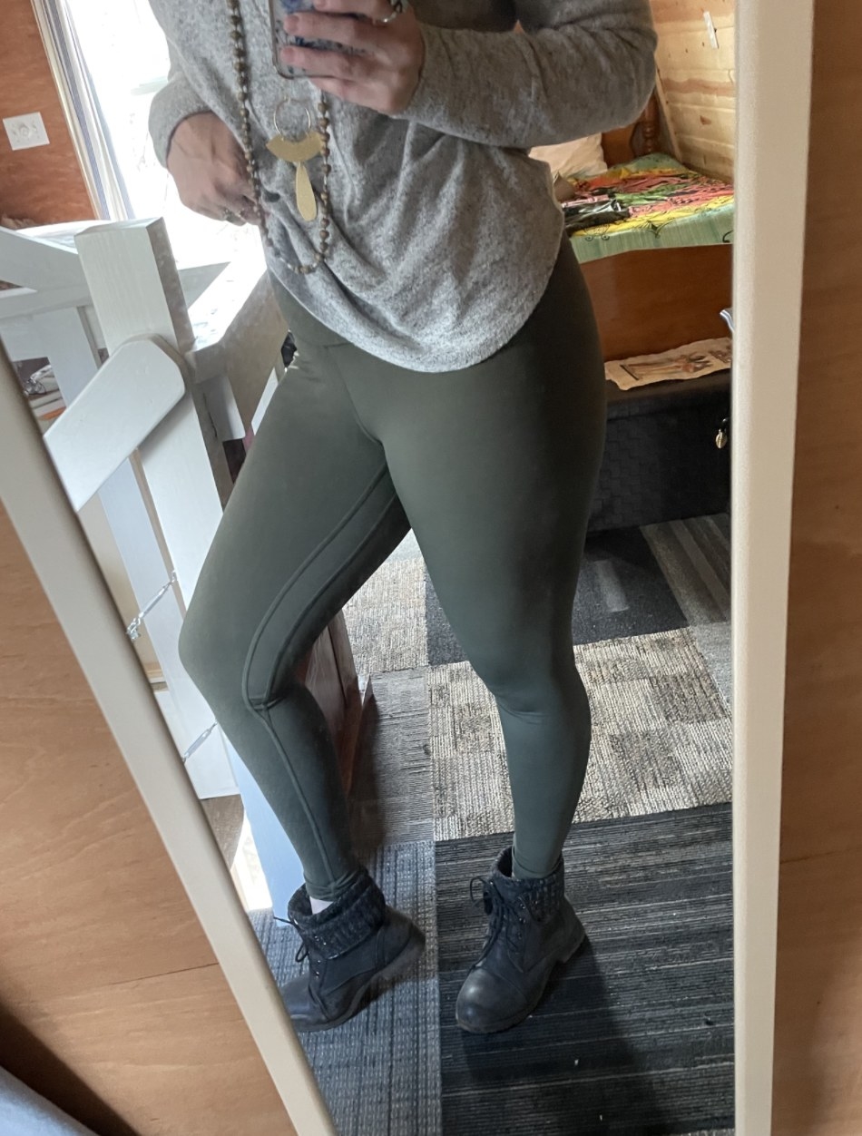 a reviewer wearing the leggings in green