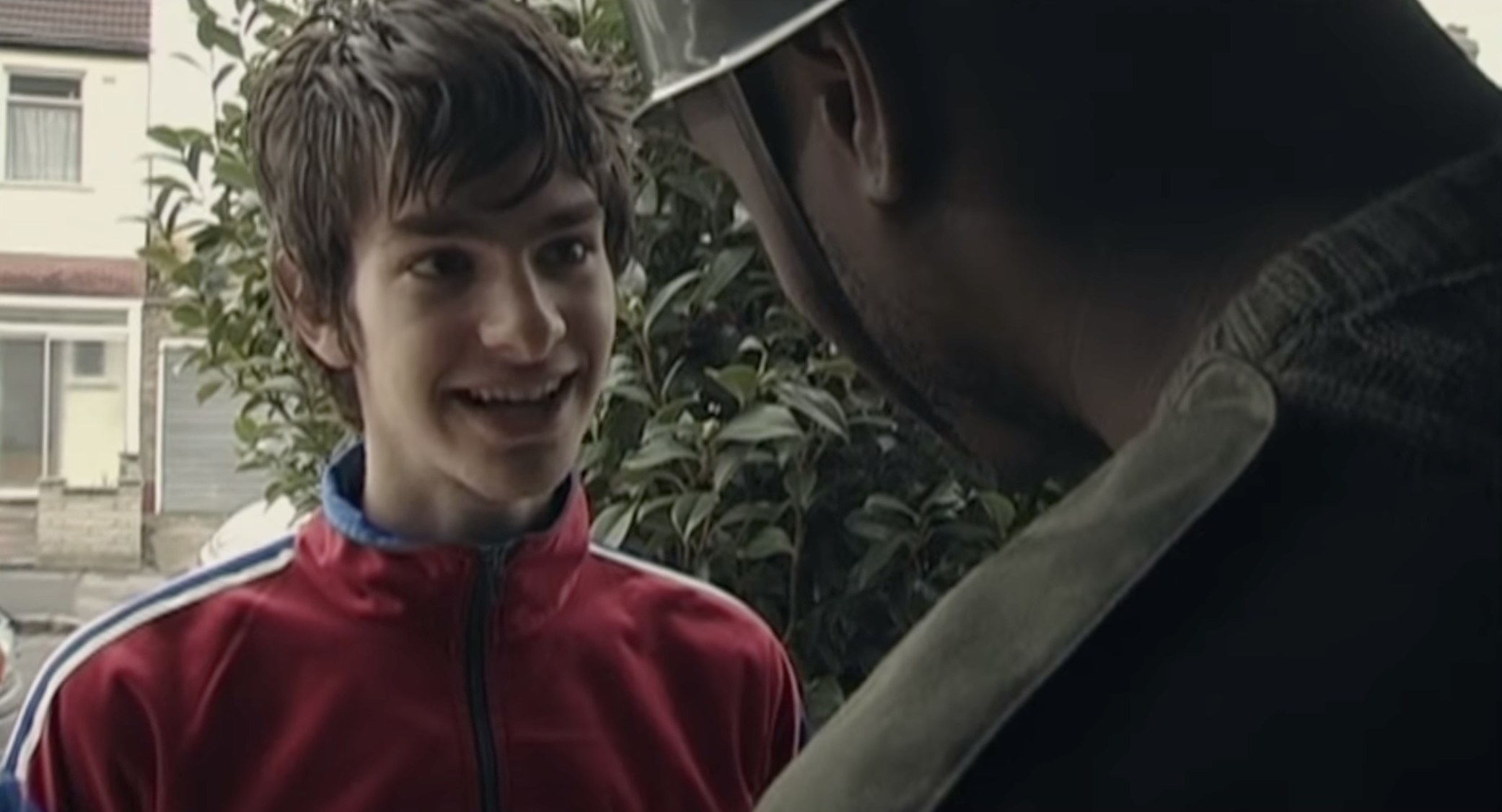 A young Andrew Garfield in a tracksuit