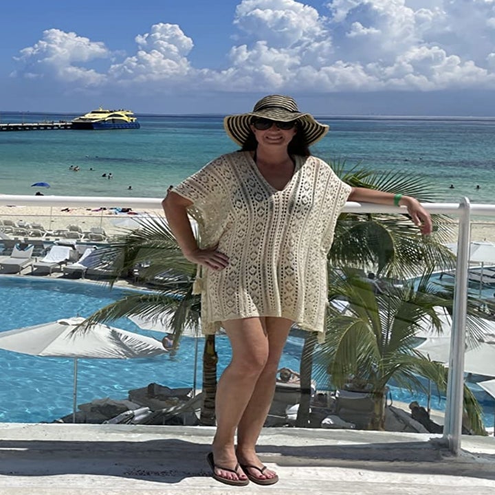 a reviewer wearing the cover up in cream