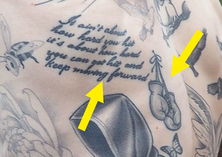 A closeup of the tattoos described