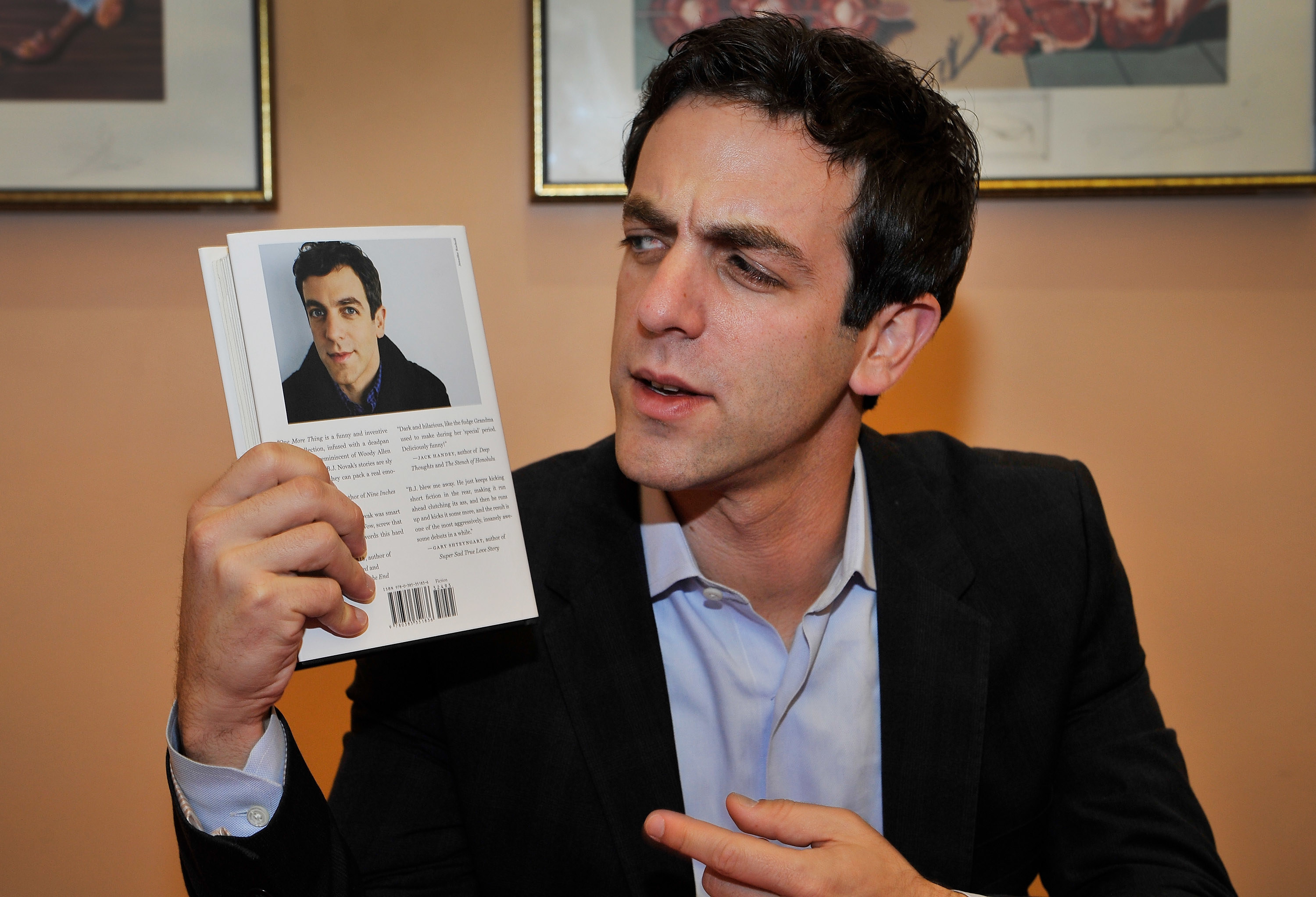 B.J. Novak holding his book &quot;One More Thing&quot; at a book festival