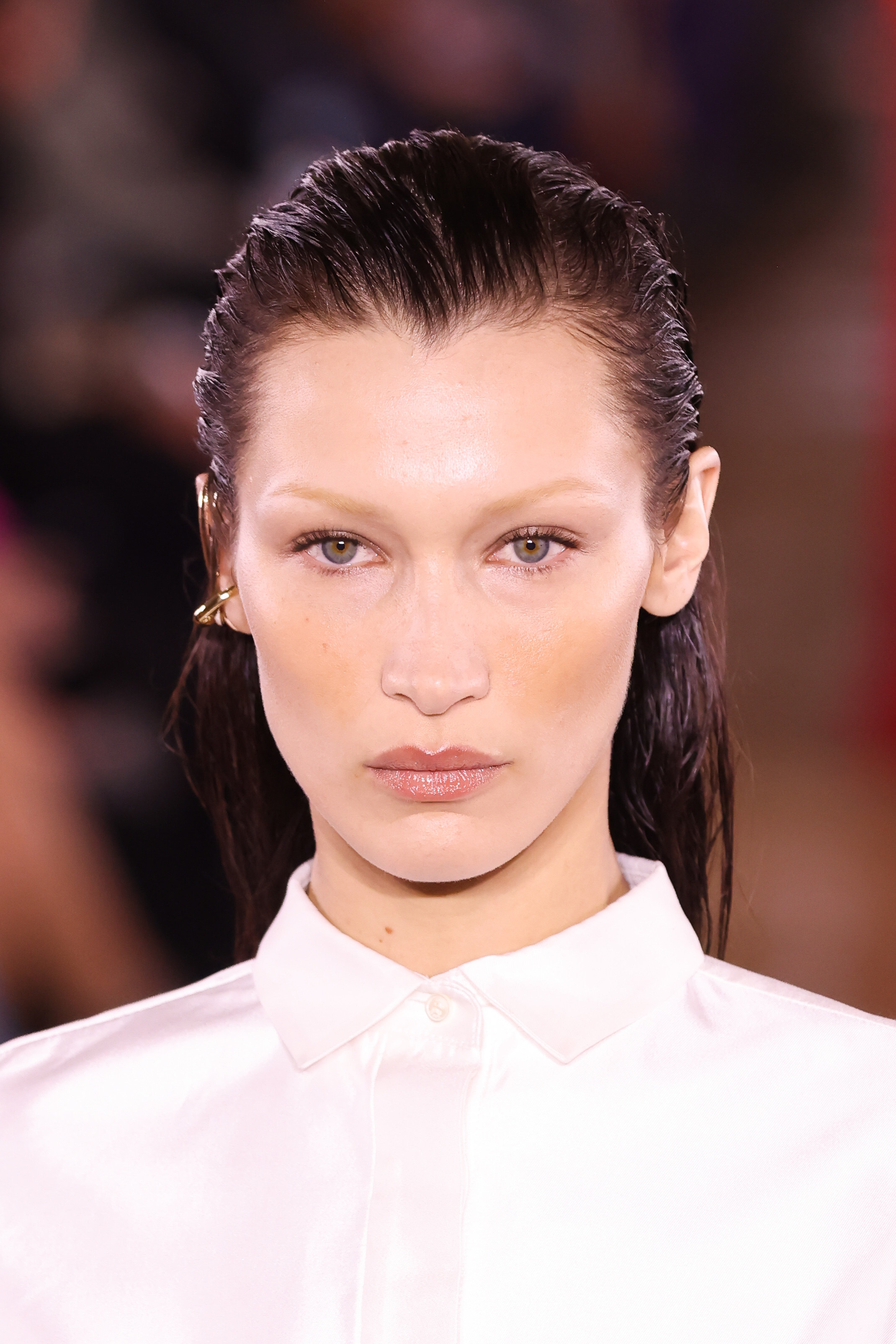 A close-up of Bella Hadid with slicked back hair