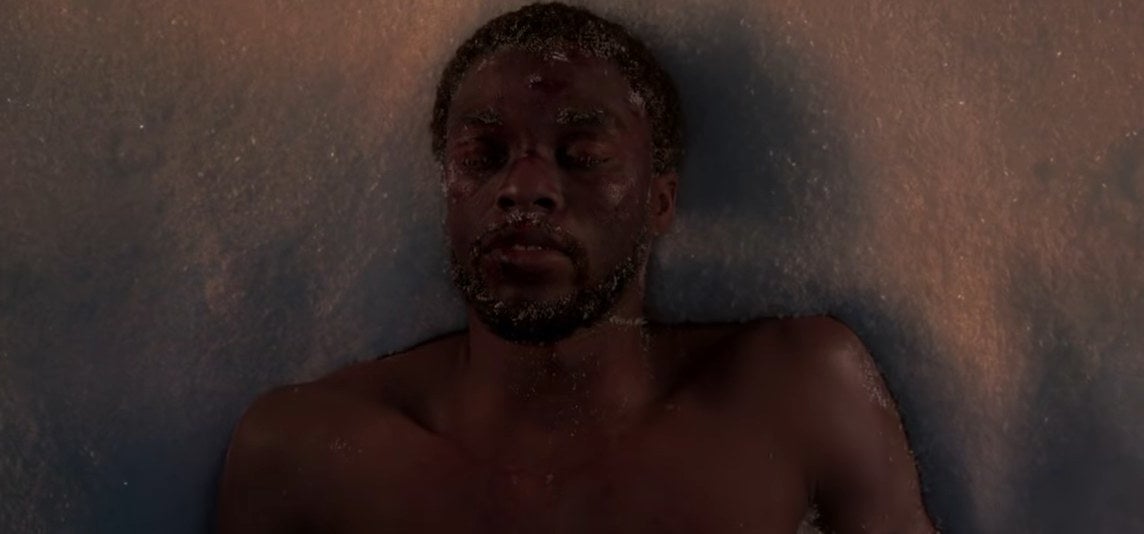T'Challa lying unconscious in a pile of snow in "Black Panther"