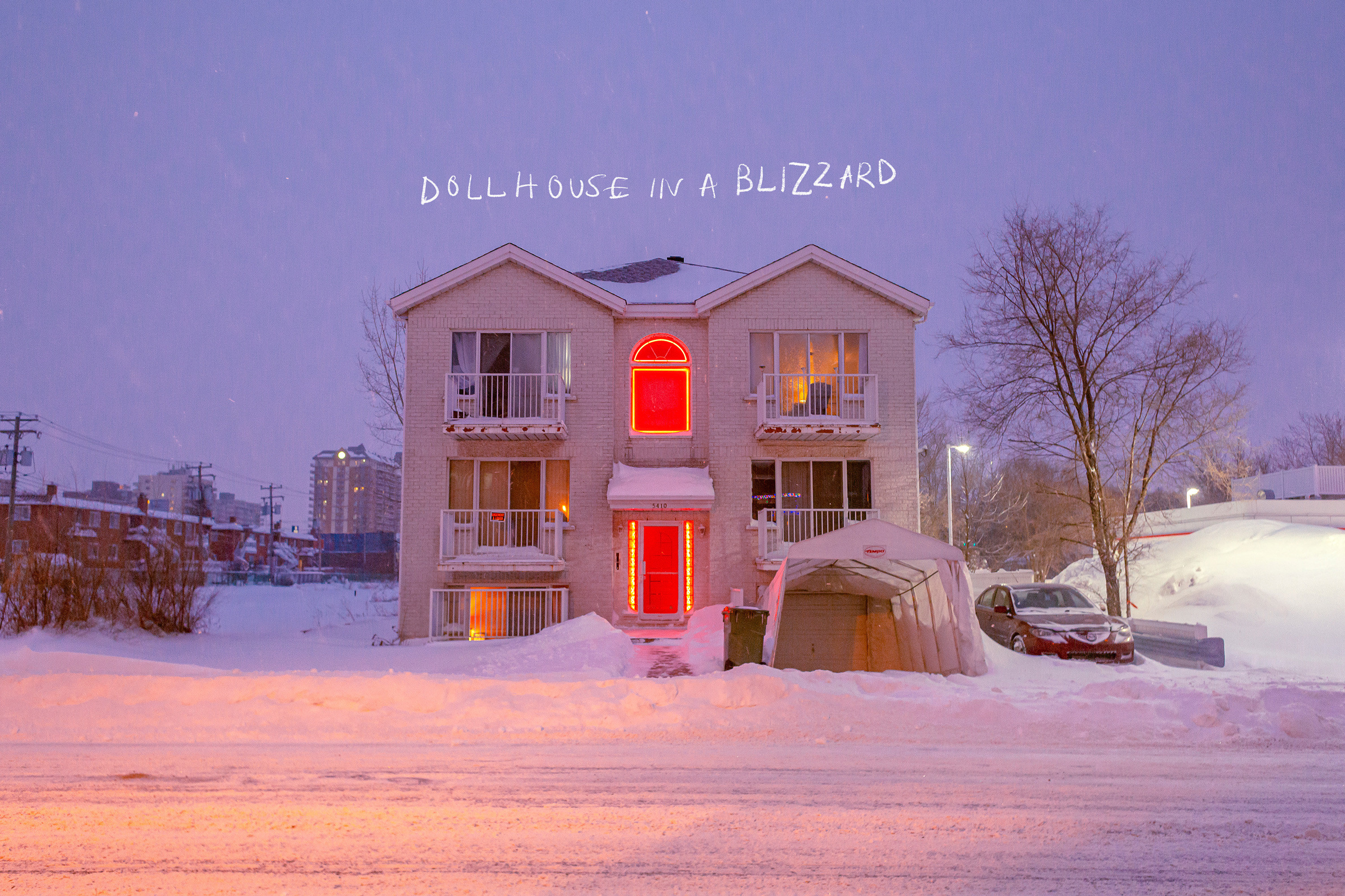 A house in the winter with the text on the image reading &quot;dollhouse in a blizzard&quot;