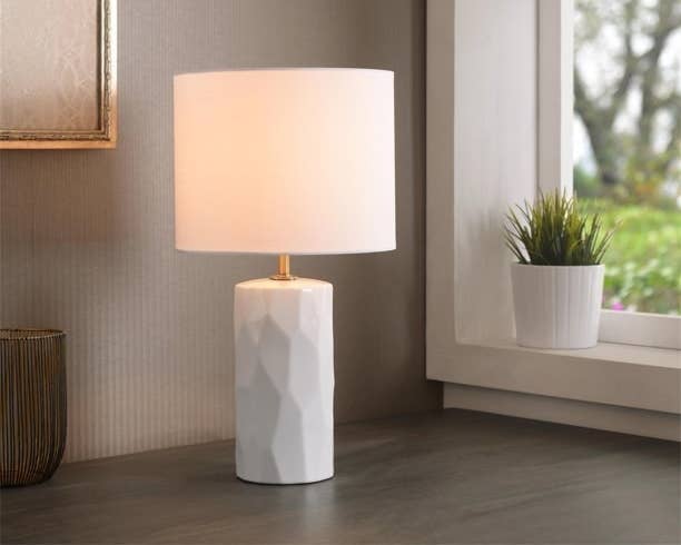 A white lamp on a table