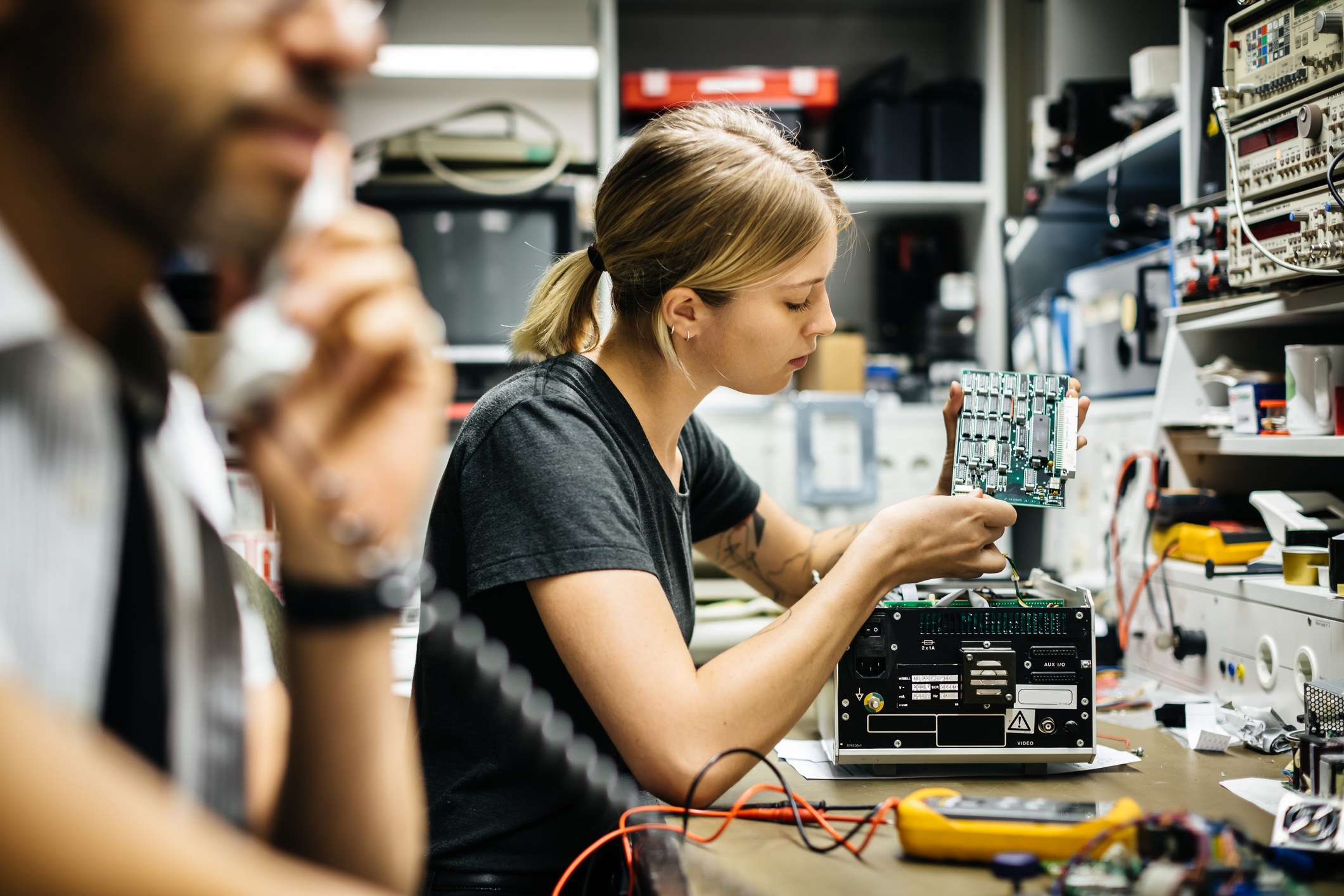 Technician working on a conductor board in workshop