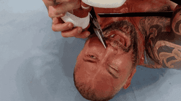 Dave Bautista has his nose clamped by players during a &quot;WrestleMania&quot; match