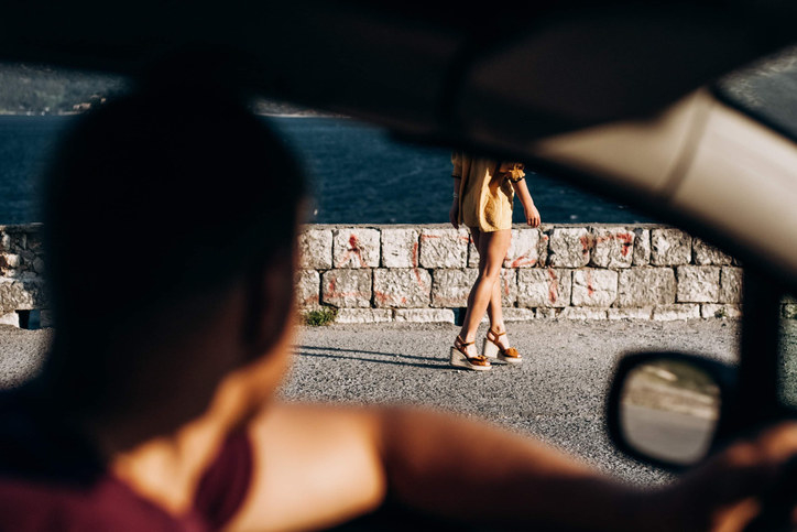 A man shouting at a woman from his car