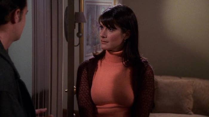 A close up of Julie Graff as she wears a turtleneck under a cardigan