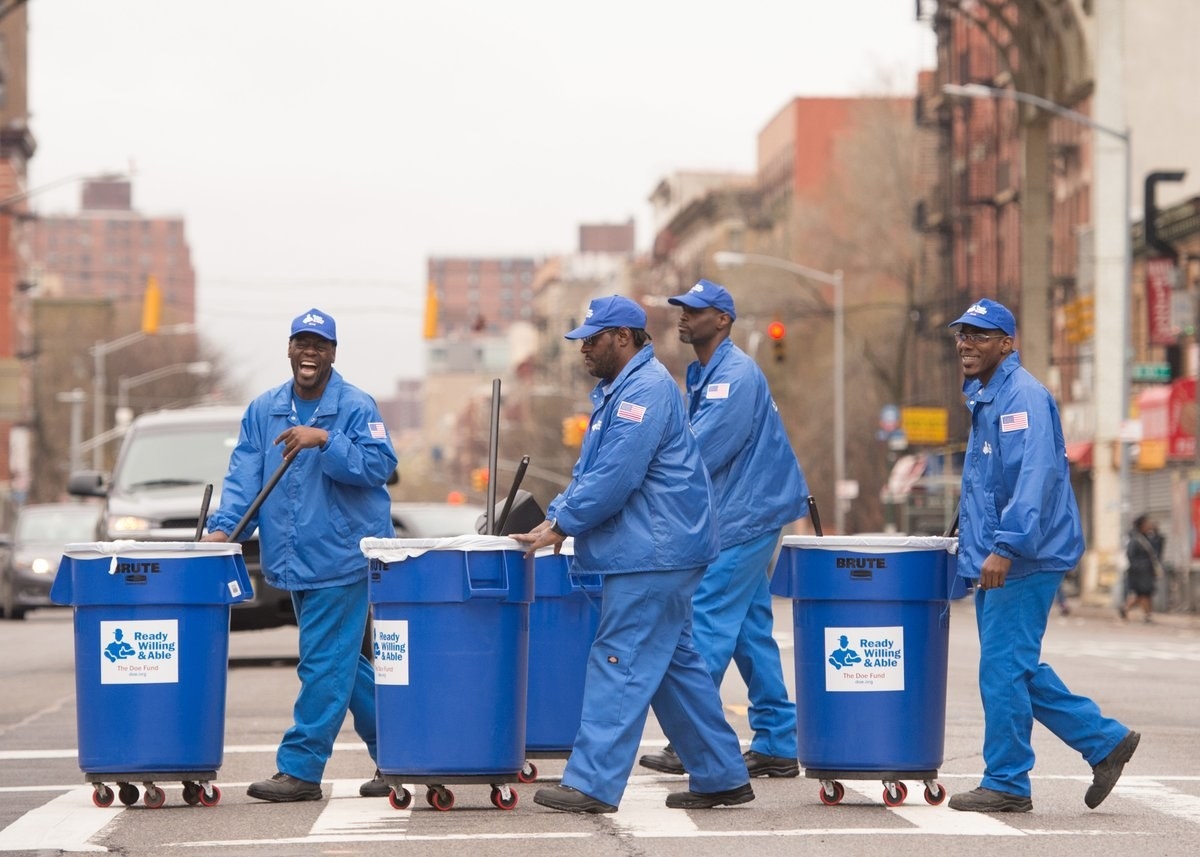 Men in Blue working on street cleaning
