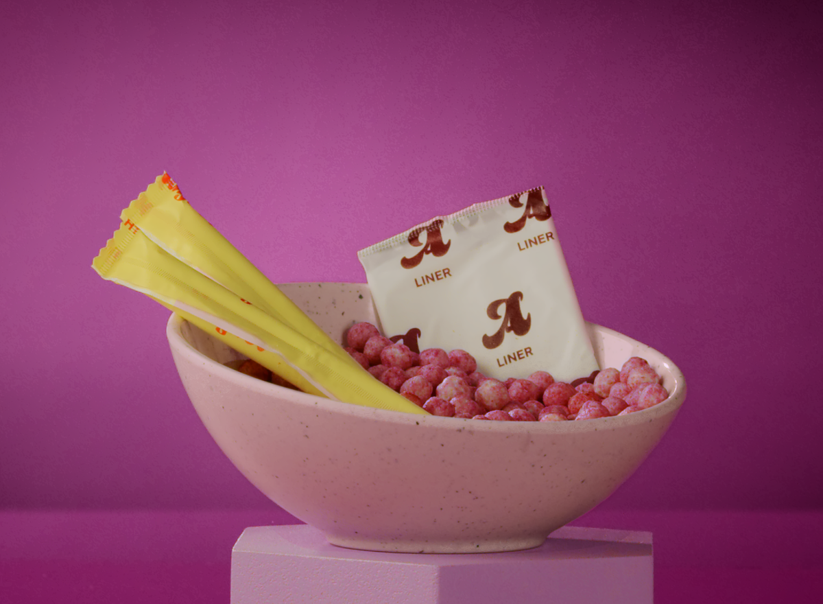 a bowl of Loopholes cereal with period products on top of the cereal in the bowl