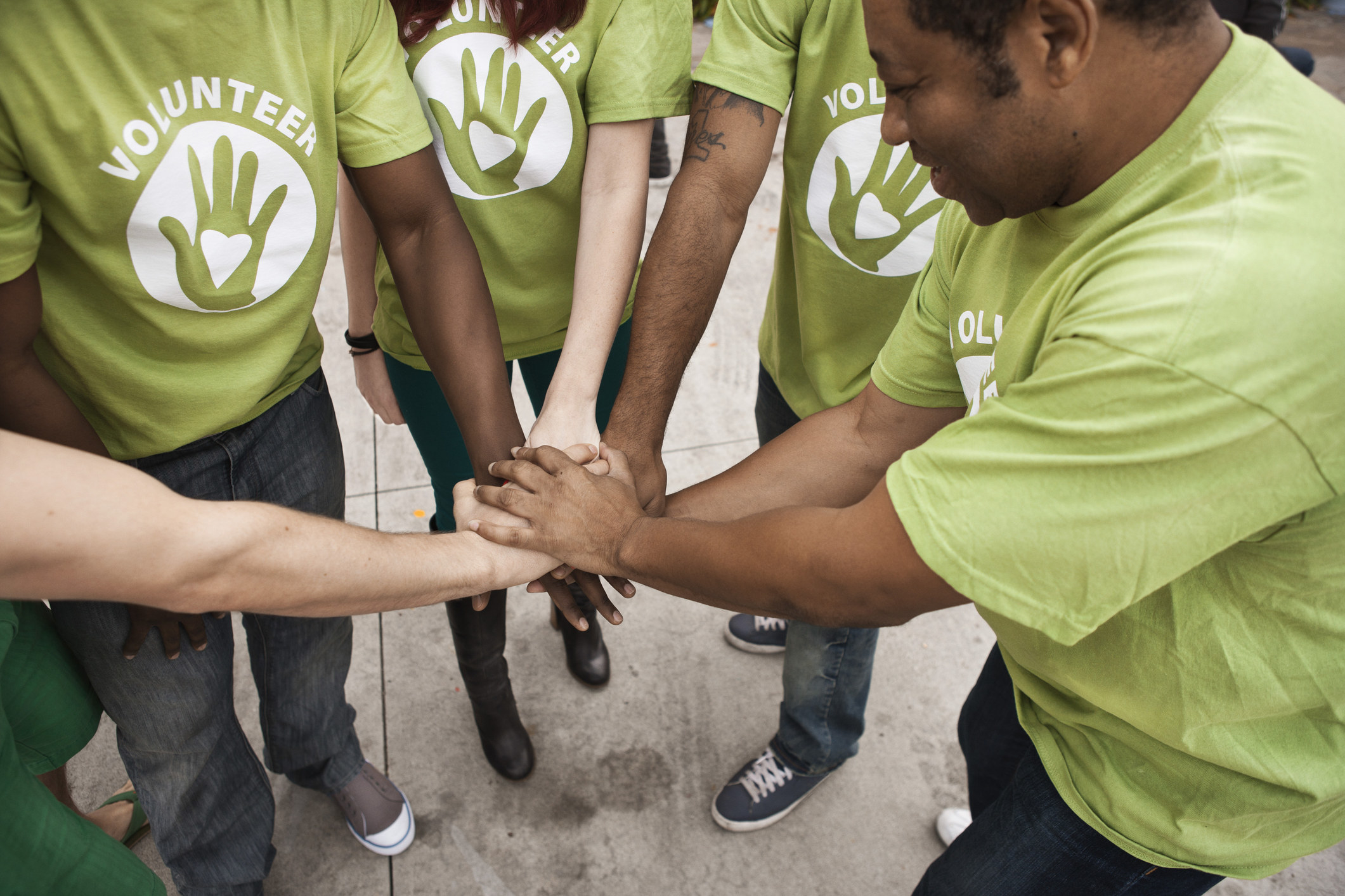 A group of volunteers putting their hands in