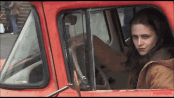 Kristen Stewart goofing around and throwing up a peace sign in Bella&#x27;s red truck