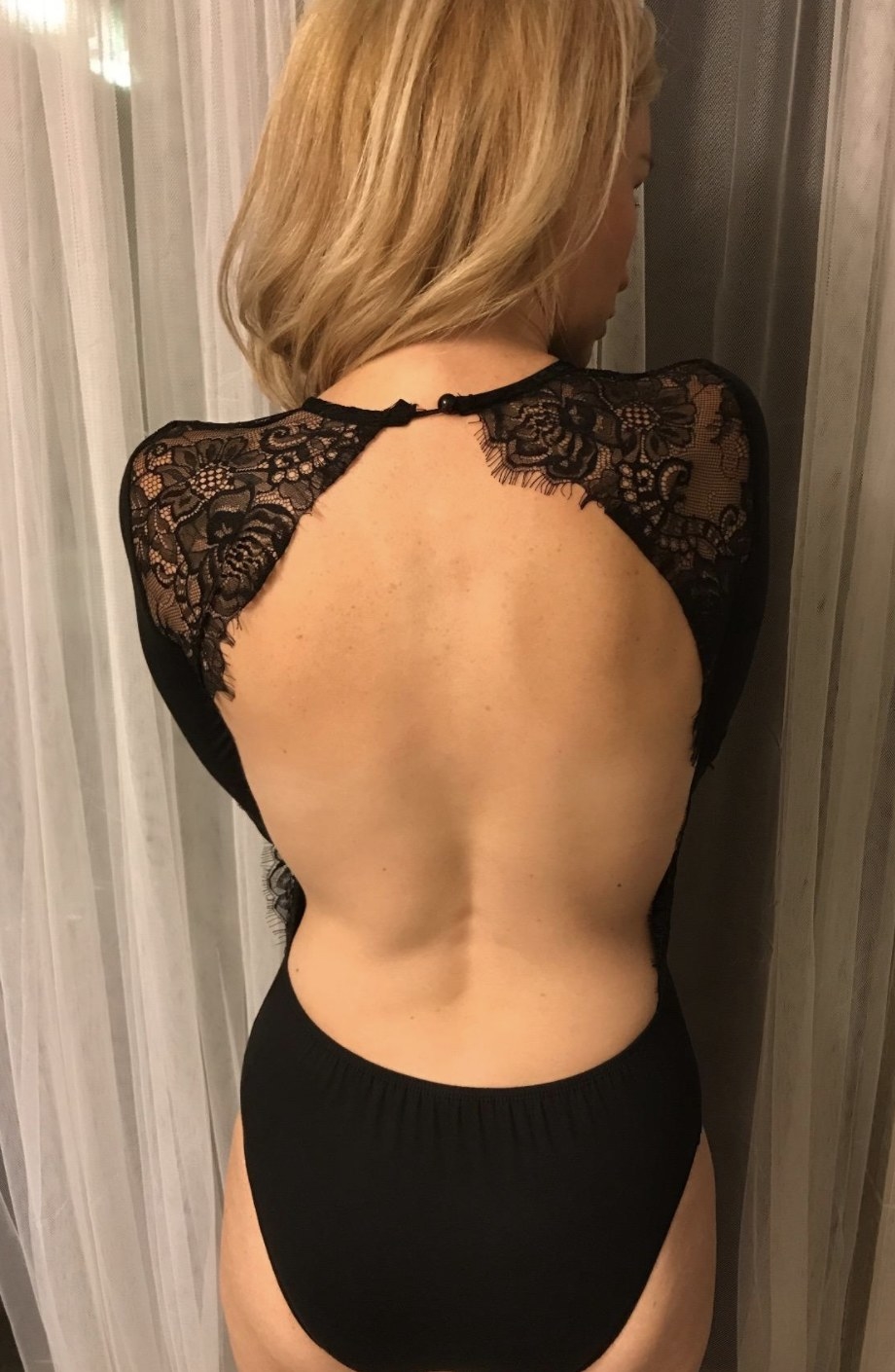 reviewer wearing backless body suit