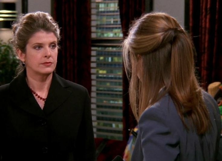 Joana stands in front of Rachel Green wearing a dark blazer