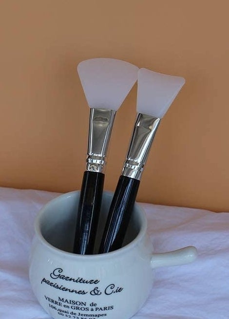 The two silicone spatulas in a cup on a table