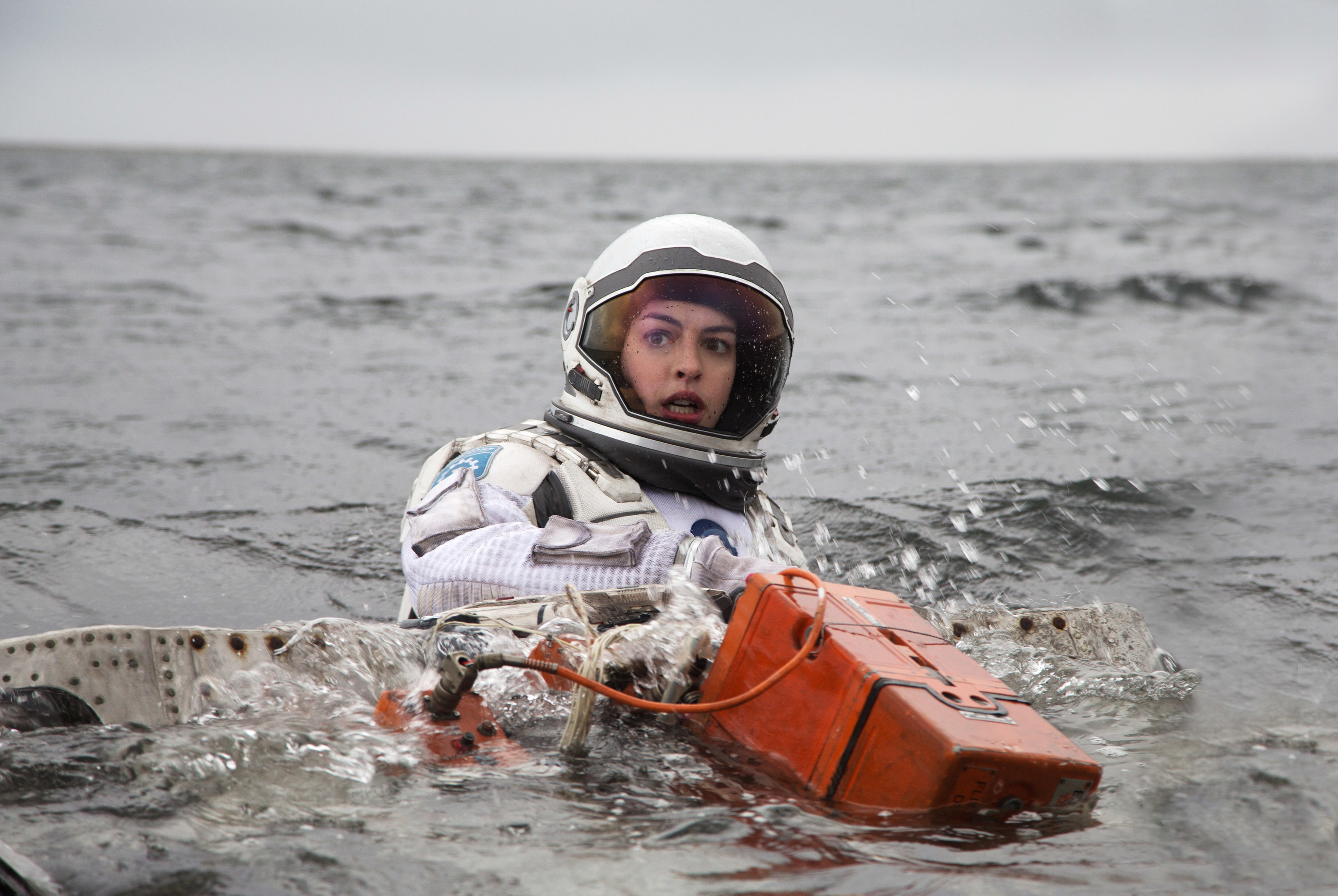 Anne Hathaway swimming in a space suit