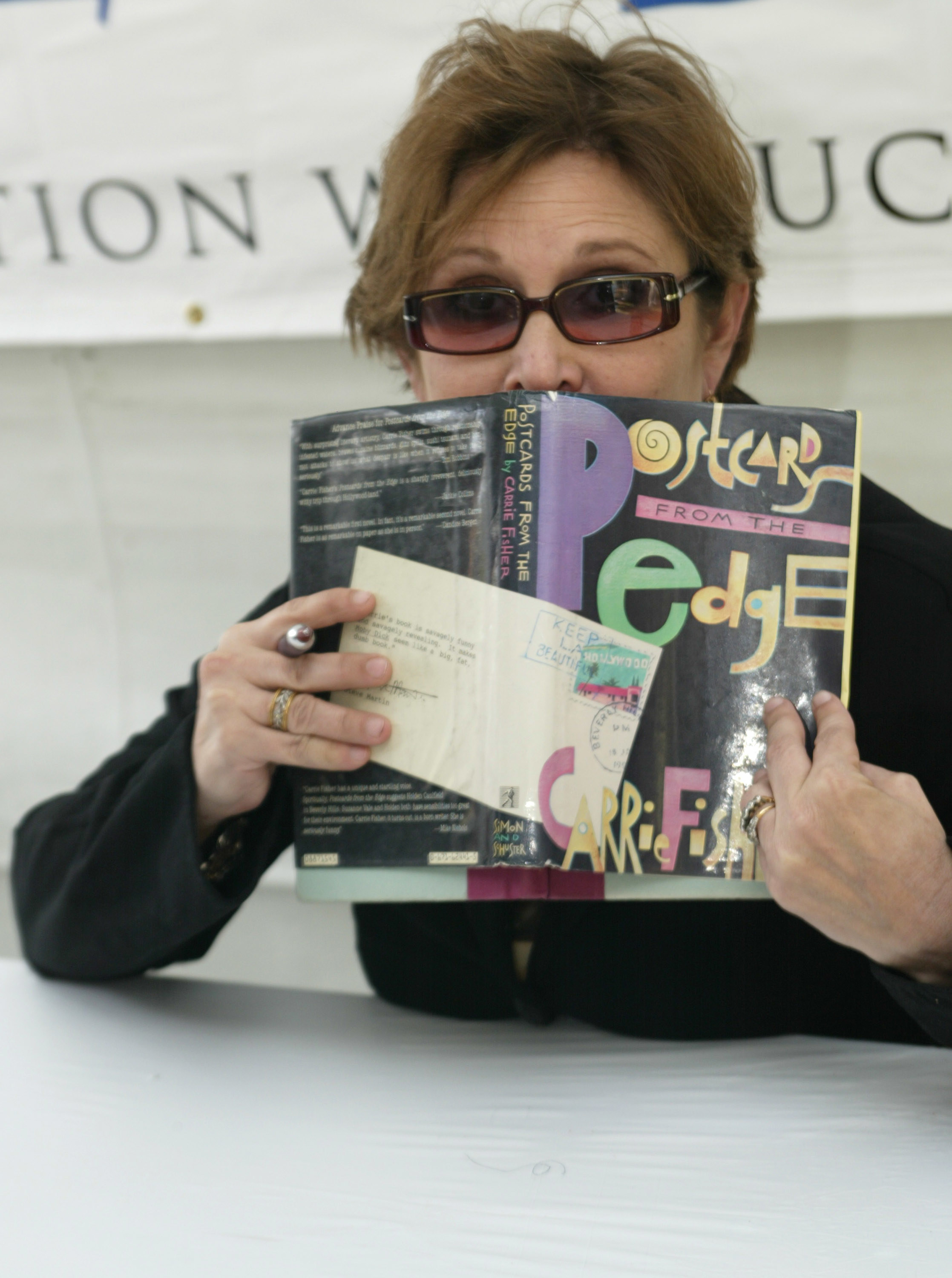 Actress/writer Carrie Fisher poses as she signs copies of her book &quot;Postcards from the Edge&quot;