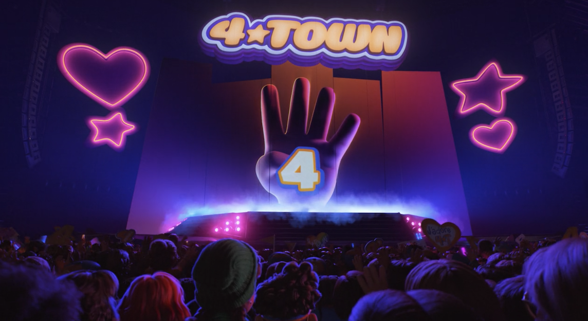 The name 4*Town, hearts, stars, and a hand with the number four over it onscreen at the concert