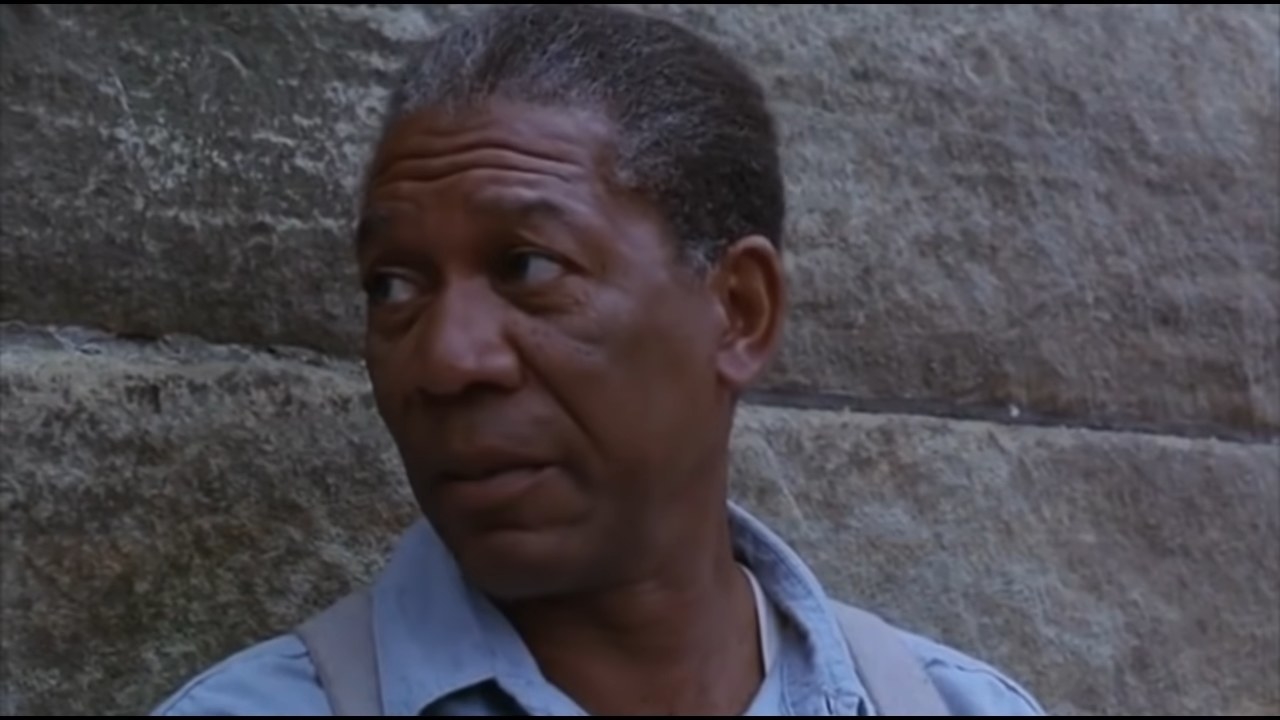 Red sitting against a wall in &quot;The Shawshank Redemption&quot;
