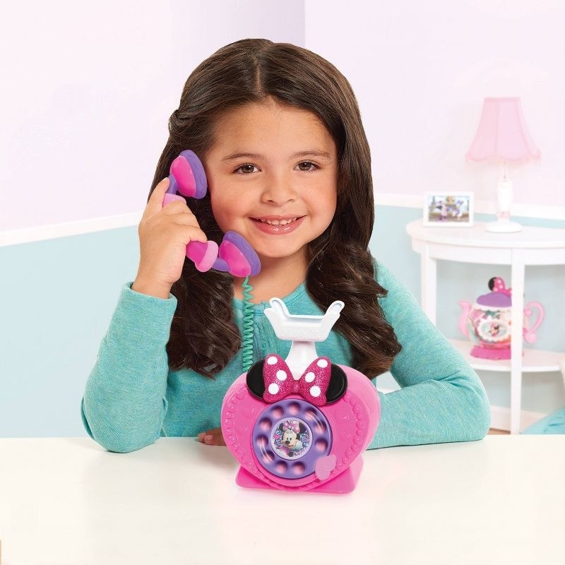Child on Minnie Mouse phone