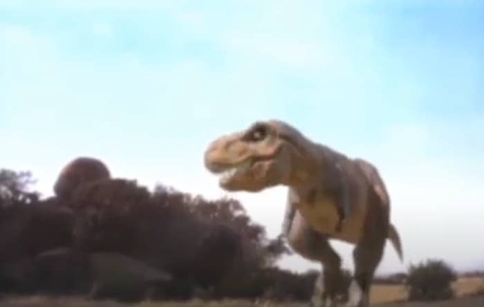 CGI T. rex walking in a field