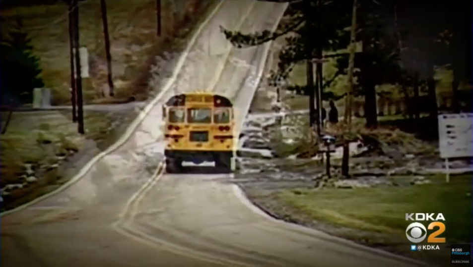 A school bus driving down a road